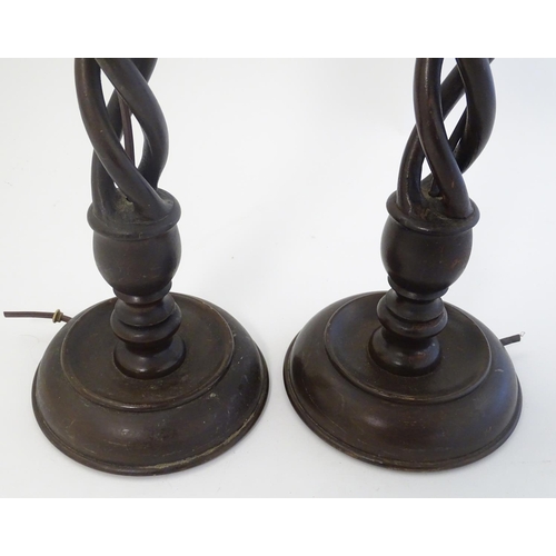 449 - A pair of mid 20thC Walnut triple open twist lampstands with circular bases ,22 1/2'' high