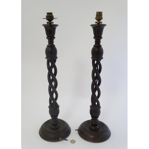 449 - A pair of mid 20thC Walnut triple open twist lampstands with circular bases ,22 1/2'' high