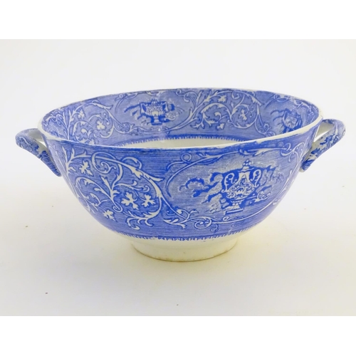 45 - A quantity of blue and white items, to include a twin handled bowl decorated with Classical urns and... 