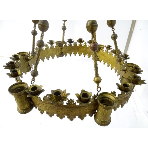 453 - Chandelier: a large Neo-Gothic circular, hanging, 2 stage brass pendant chandelier having 6 ornate s... 