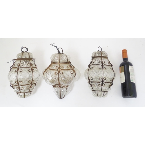 459 - Three pendant Islamic electrified pendant steel framed clear glass lamps, each with hinged tops, eac... 