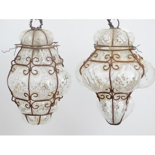 459 - Three pendant Islamic electrified pendant steel framed clear glass lamps, each with hinged tops, eac... 