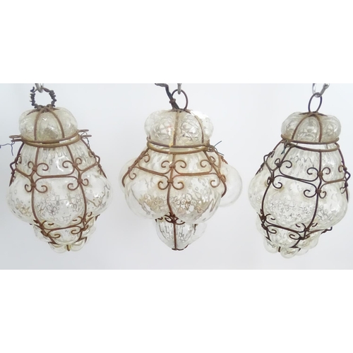 459 - Three pendant Islamic electrified pendant steel framed clear glass lamps, each with hinged tops, eac... 