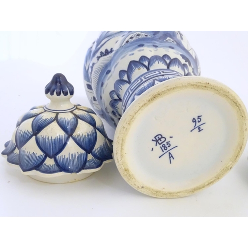 46 - Two blue and white ginger jars decorated with buildings in a landscape, and banded petal and geometr... 