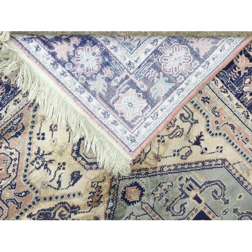 517 - Carpet / Rug: a hand woven silk rug with central hexagonal light blue ground, surrounded by a light ... 