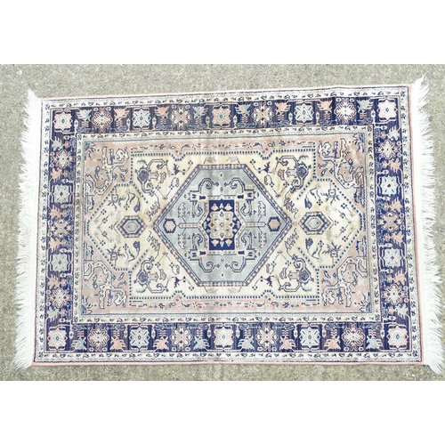 517 - Carpet / Rug: a hand woven silk rug with central hexagonal light blue ground, surrounded by a light ... 