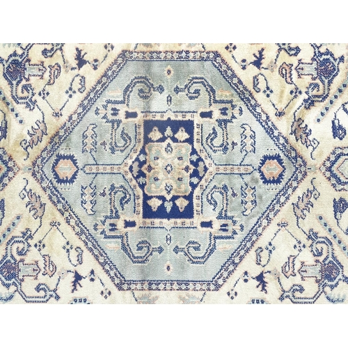 517 - Carpet / Rug: a hand woven silk rug with central hexagonal light blue ground, surrounded by a light ... 