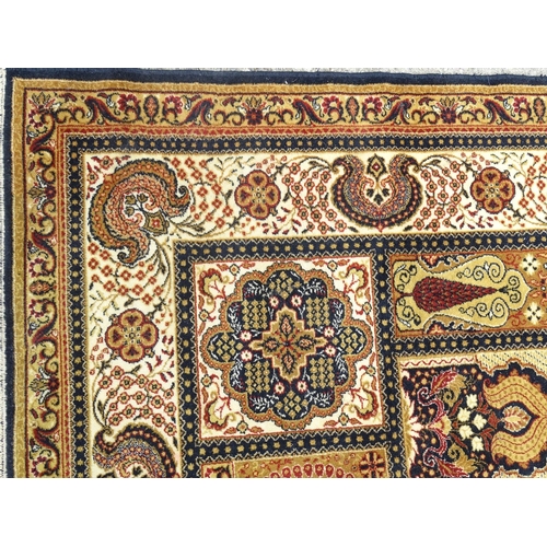 519 - Rug / Carpet: a large handmade woollen carpet, having mustard, black, yellow, red, cream etc. colour... 