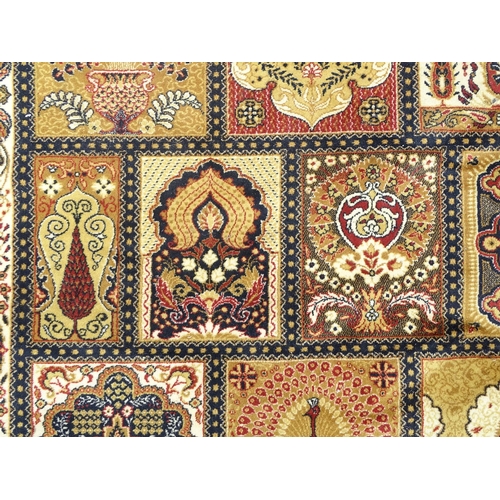 519 - Rug / Carpet: a large handmade woollen carpet, having mustard, black, yellow, red, cream etc. colour... 