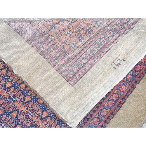 520 - Carpet / Rug : a hand woven Signed Runner with a red central ground, blue, navy blue, pink, black an... 