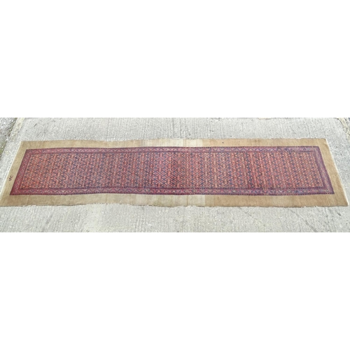 520 - Carpet / Rug : a hand woven Signed Runner with a red central ground, blue, navy blue, pink, black an... 