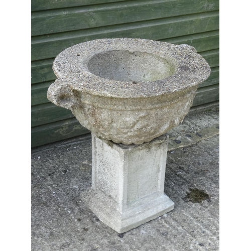 531 - A reconstituted stone urn with associated squared plinth , 25'' high