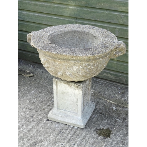 531 - A reconstituted stone urn with associated squared plinth , 25'' high