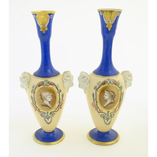 59 - A pair of vases with hand painted Roman portraits in roundels surrounded by scrolling decoration, an... 