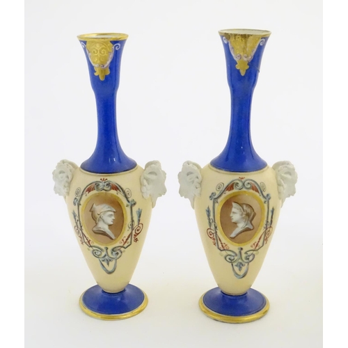 59 - A pair of vases with hand painted Roman portraits in roundels surrounded by scrolling decoration, an... 