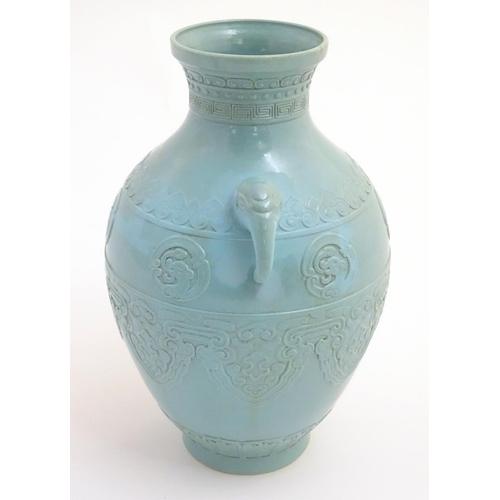 6 - A Chinese celadon baluster vase with twin handles formed as elephant heads, decorated with scrolling... 