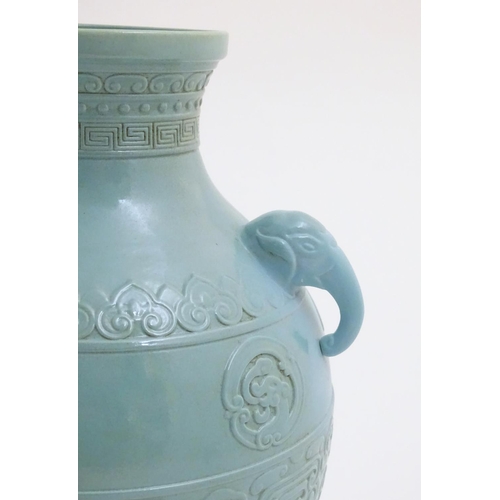 6 - A Chinese celadon baluster vase with twin handles formed as elephant heads, decorated with scrolling... 