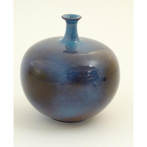 62 - A high fired globular vase with a flared rim. Approx. 9 1/2'' high.