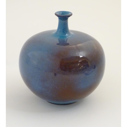 62 - A high fired globular vase with a flared rim. Approx. 9 1/2'' high.