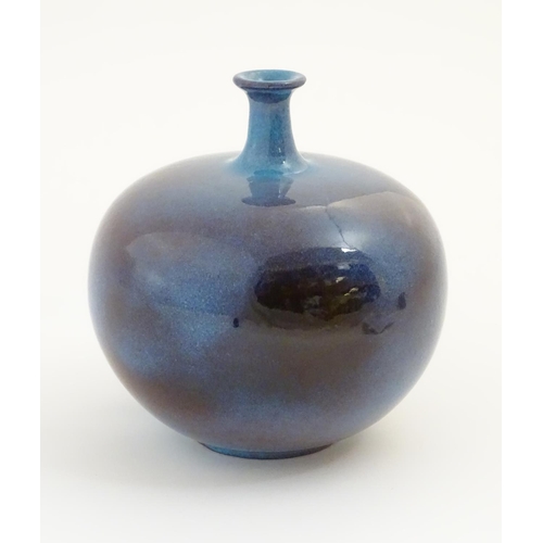 62 - A high fired globular vase with a flared rim. Approx. 9 1/2'' high.