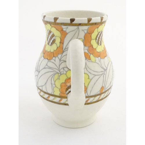 69 - A Crown Ducal single handled vase/jug, model 146, designed by Charlotte Rhead, decorated in the 'Tud... 