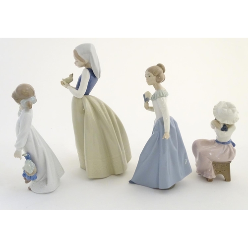 74 - Four Nao (by Lladro) figures, comprising 'My Rag Doll' no. 1108, a young girl holding her rag doll, ... 