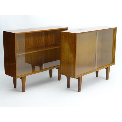 750 - Vintage Retro - a pair of English mid 20 thC 'Gordon Russell' Walnut low bookcases with sliding glas... 