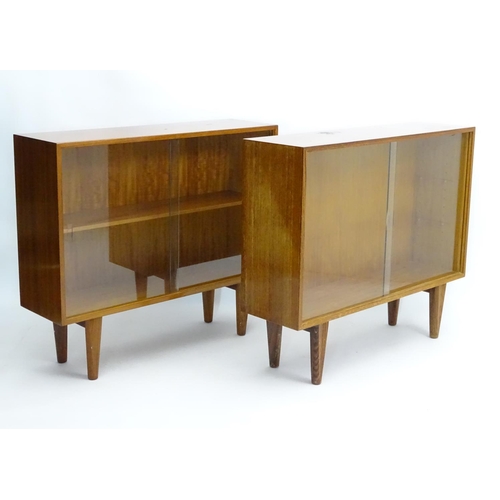 750 - Vintage Retro - a pair of English mid 20 thC 'Gordon Russell' Walnut low bookcases with sliding glas... 