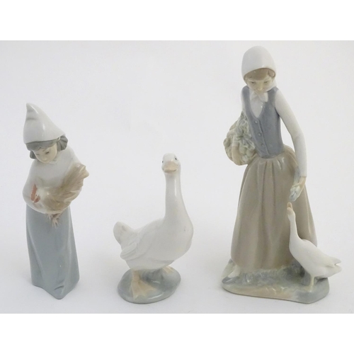 76 - A quantity of Lladro and Nao figures, to include two Lladro penguins and girl holding a chicken, a N... 