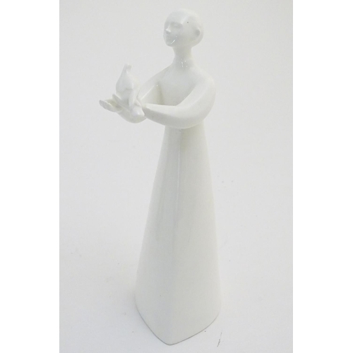 76 - A quantity of Lladro and Nao figures, to include two Lladro penguins and girl holding a chicken, a N... 