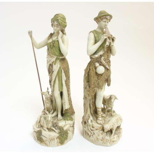 79 - A pair of early 20thC Royal Dux Bohemia figures comprising a shepherd playing the flute and a shephe... 