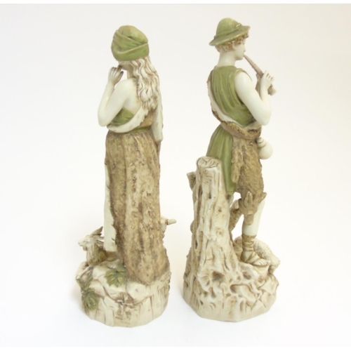 79 - A pair of early 20thC Royal Dux Bohemia figures comprising a shepherd playing the flute and a shephe... 