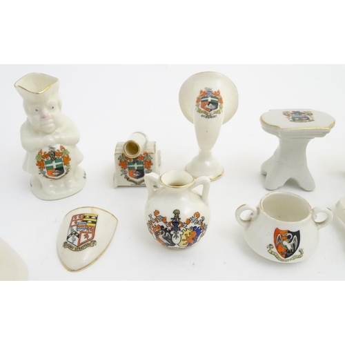 83 - A quantity of local interest crested ware of various forms, including a miniature Toby jug, cups, ju... 