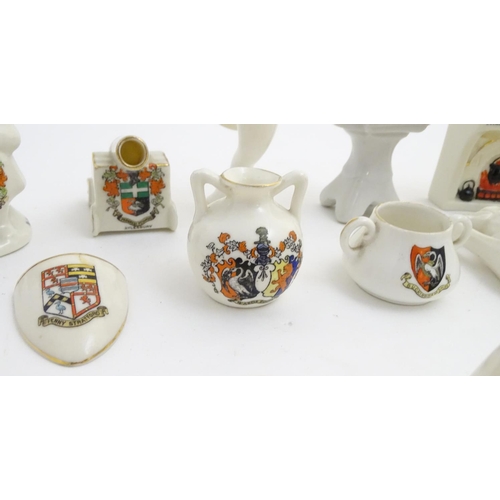 83 - A quantity of local interest crested ware of various forms, including a miniature Toby jug, cups, ju... 