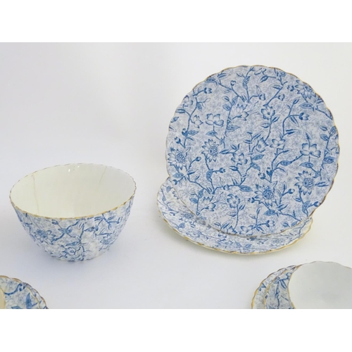 84 - A quantity of late 19th/early 20thC teawares with a blue and white flower transfer decoration, with ... 