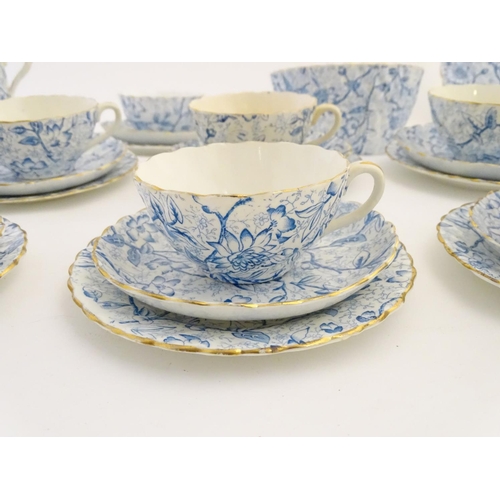 84 - A quantity of late 19th/early 20thC teawares with a blue and white flower transfer decoration, with ... 