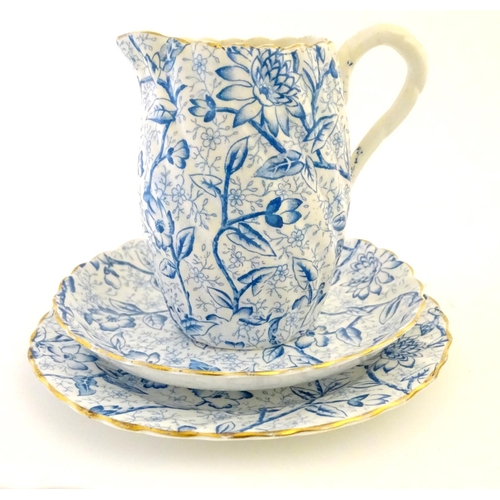 84 - A quantity of late 19th/early 20thC teawares with a blue and white flower transfer decoration, with ... 