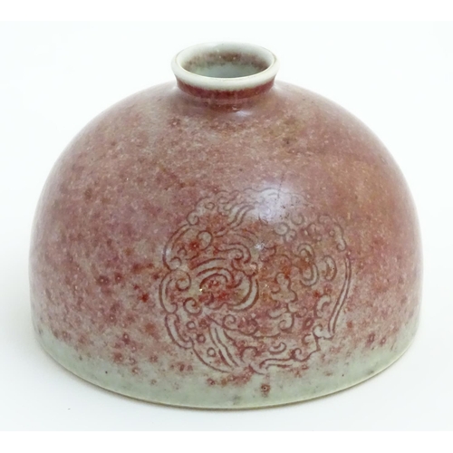 9 - A Chinese sang-de-boeuf pot/taibai zun formed as a dome, decorated with three stylised dragon rounde... 