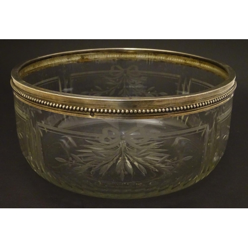 90 - A circa 1900 silver plate rimmed glass bowl , with star cut base and wheel cut ribbon and foliate de... 