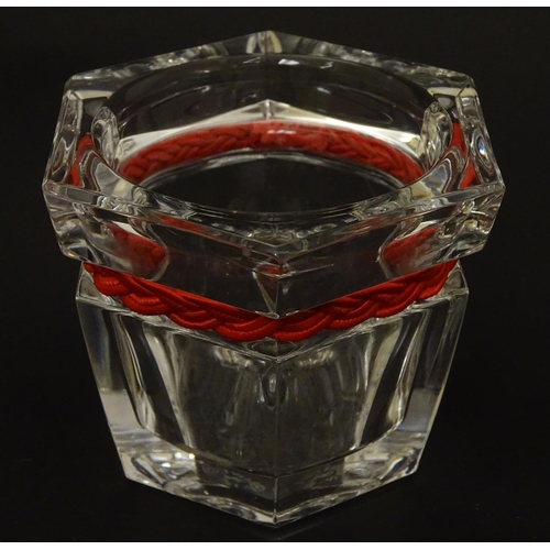 93 - Ralph Lauren : a hexagonal clear glass small bowl with plaited red strung band , 2 3/4'' high x 3'' ... 