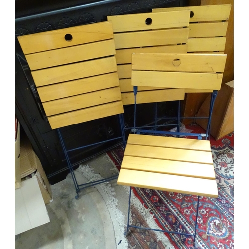 128 - A set of four folding wooden chairs