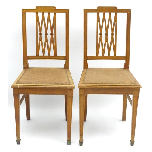 130 - A pair of early 20thC satinwood side chairs having ebonised stringing to the frame and having a pier... 