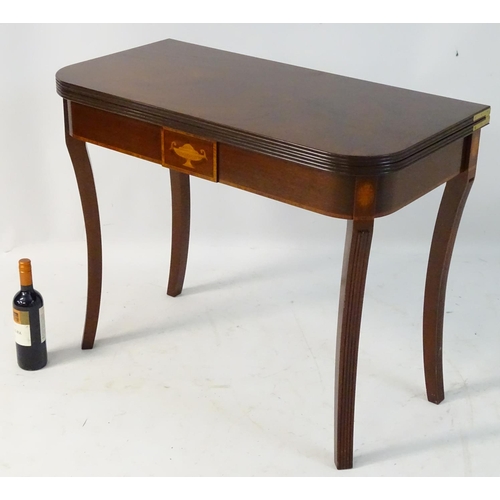 137 - An early 21stC mahogany tea table with Sheraton revival motifs and standing on fluted cabriole legs.... 