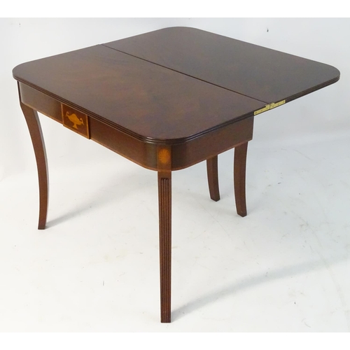 137 - An early 21stC mahogany tea table with Sheraton revival motifs and standing on fluted cabriole legs.... 