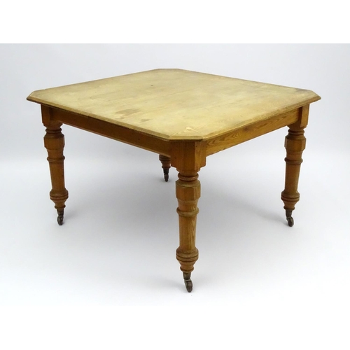 140 - An early 20thC ash dining table with chamfered and baluster turned legs terminating in ceramic casto... 