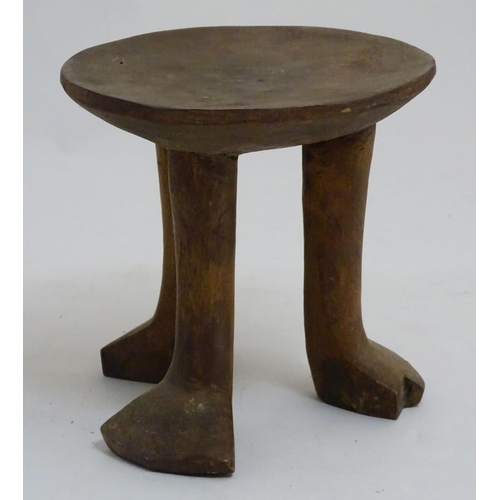 152 - A Native Tribal African 3 legged  stool made of carved wood, 7 1/2'' high.