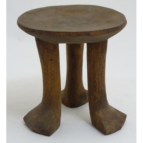 152 - A Native Tribal African 3 legged  stool made of carved wood, 7 1/2'' high.