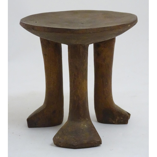 152 - A Native Tribal African 3 legged  stool made of carved wood, 7 1/2'' high.