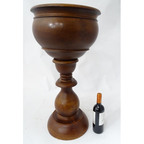 178 - A turned wooden jardiniere stand