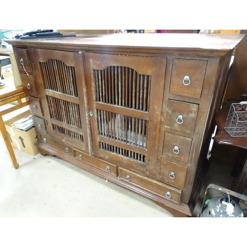 196 - A large oriental cabinet with two ventilated central drawers